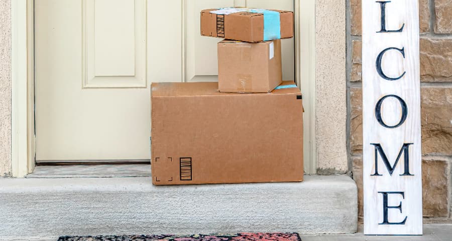 Packages on the doorstep of a home with a welcome sign in Tallahassee